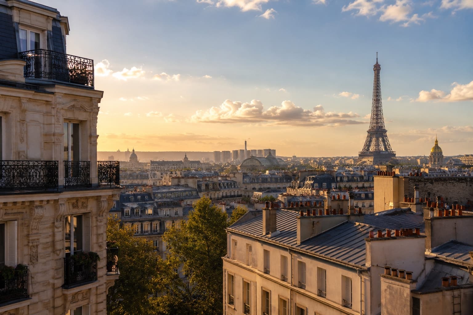 Rooftop view over Haussmann-era Paris apartment buildings toward the Eiffel Tower at sunset.